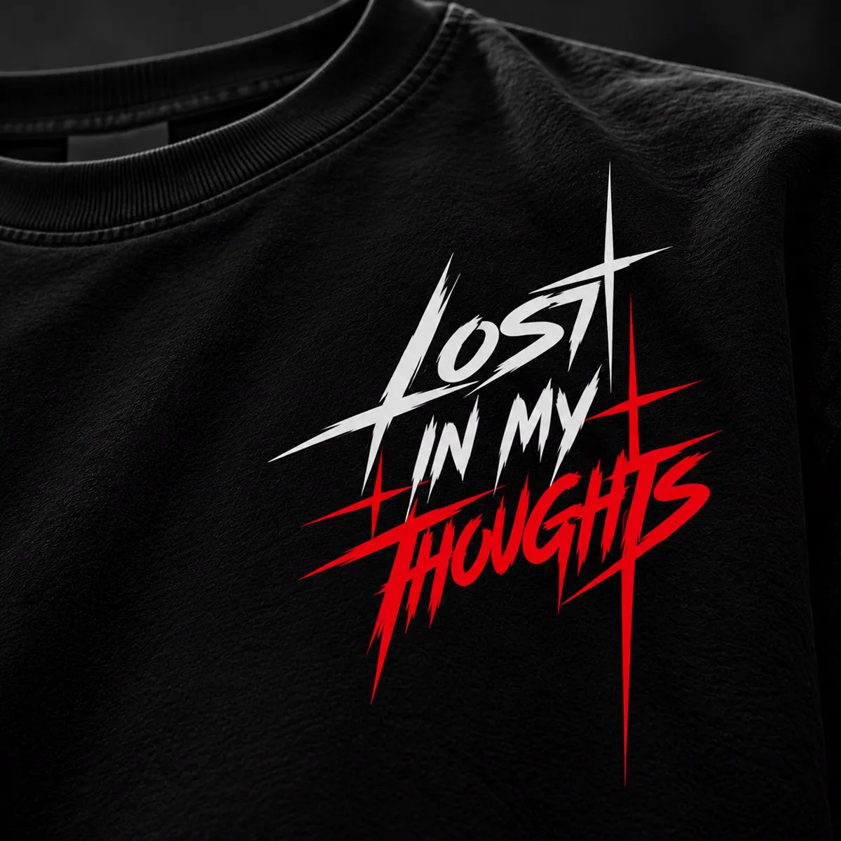 Close-up of white and red LOST IN MY THOUGHTS vinyl lettering on black fabric