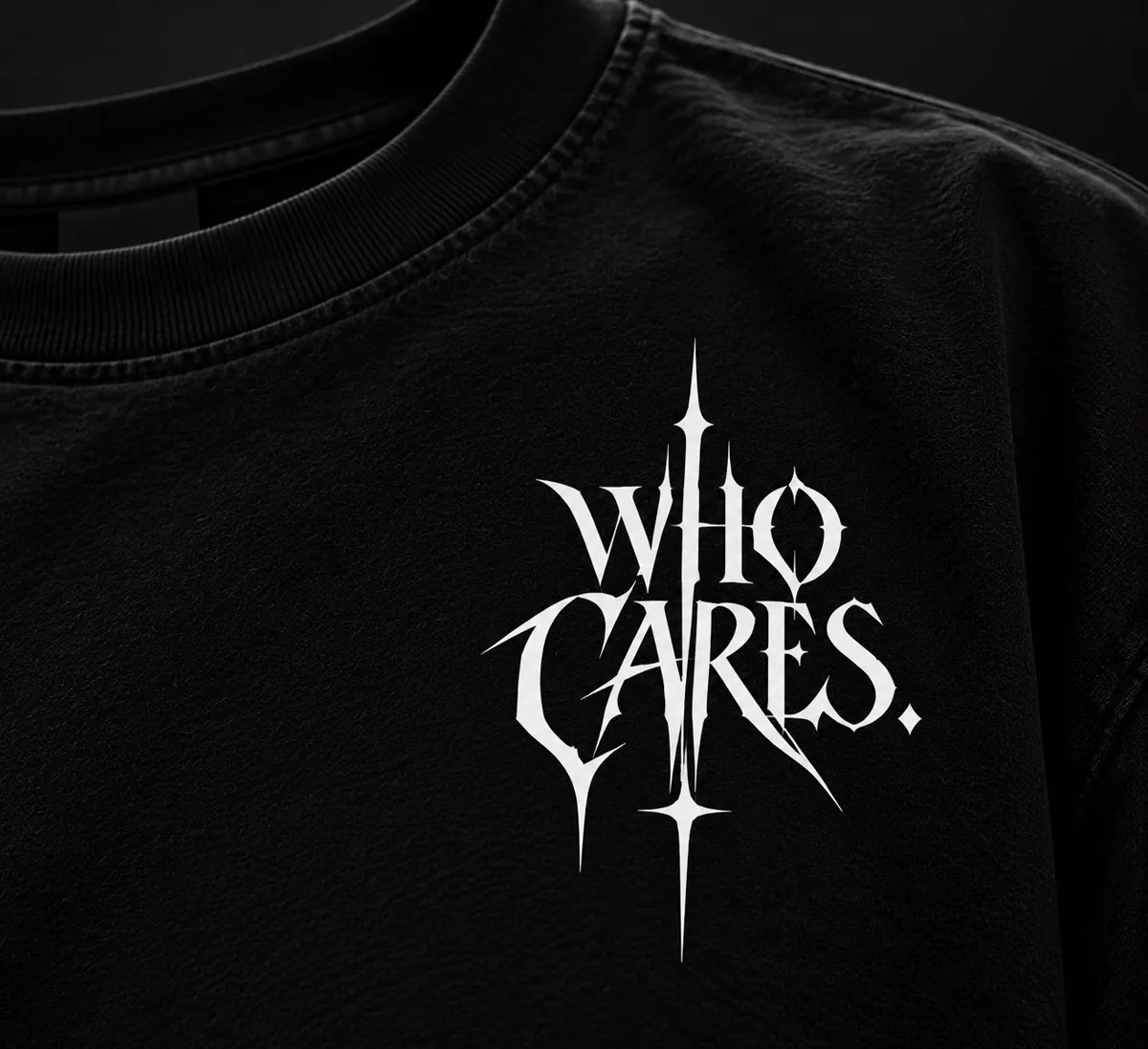 Close-up of white gothic WHO CARES vinyl lettering on black fabric
